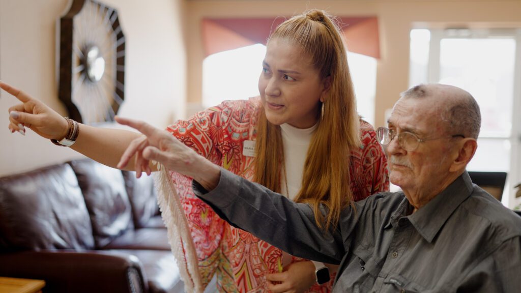 A staff worker works with a resident at a skilled nursing facility
