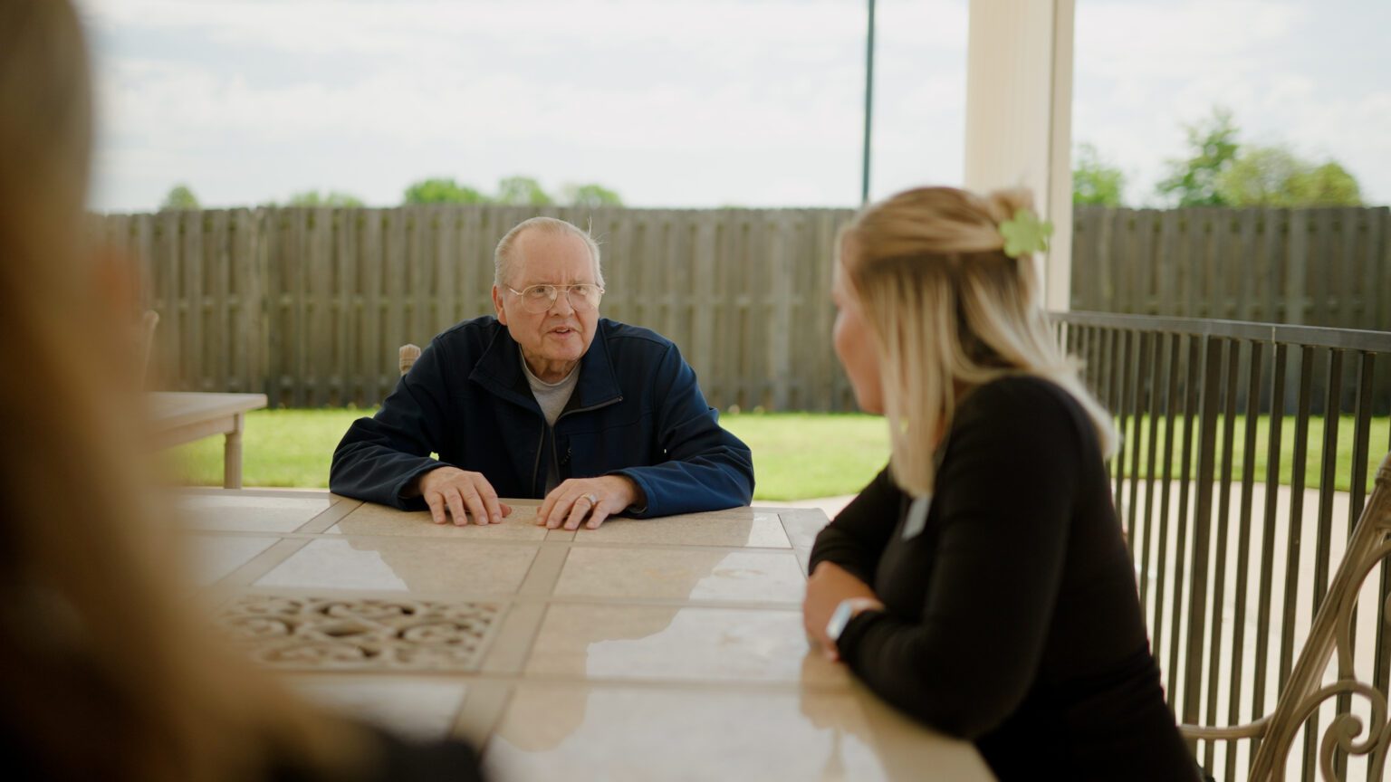 A man speaks to a nurse at a skilled nursing facility
